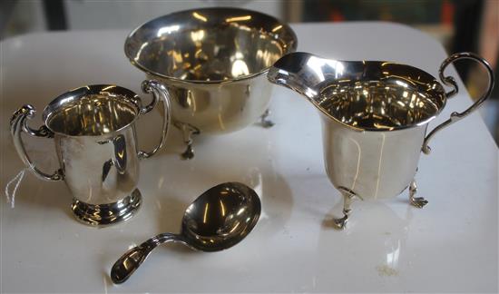 Small silver cream jug, sugar bowl, caddy spoon and a trophy cup